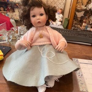 Charming Doll with Pink Cardigan and Gray Skirt